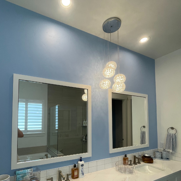 Freshly painted bathroom interior with mirror and lighting
