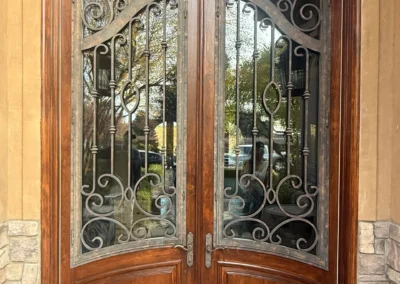 Decorative wood doors with rich stain and detailed glass inserts
