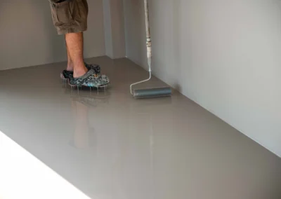 Interior concrete floor during epoxy application process