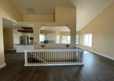 Open living area with neutral painted walls and railing
