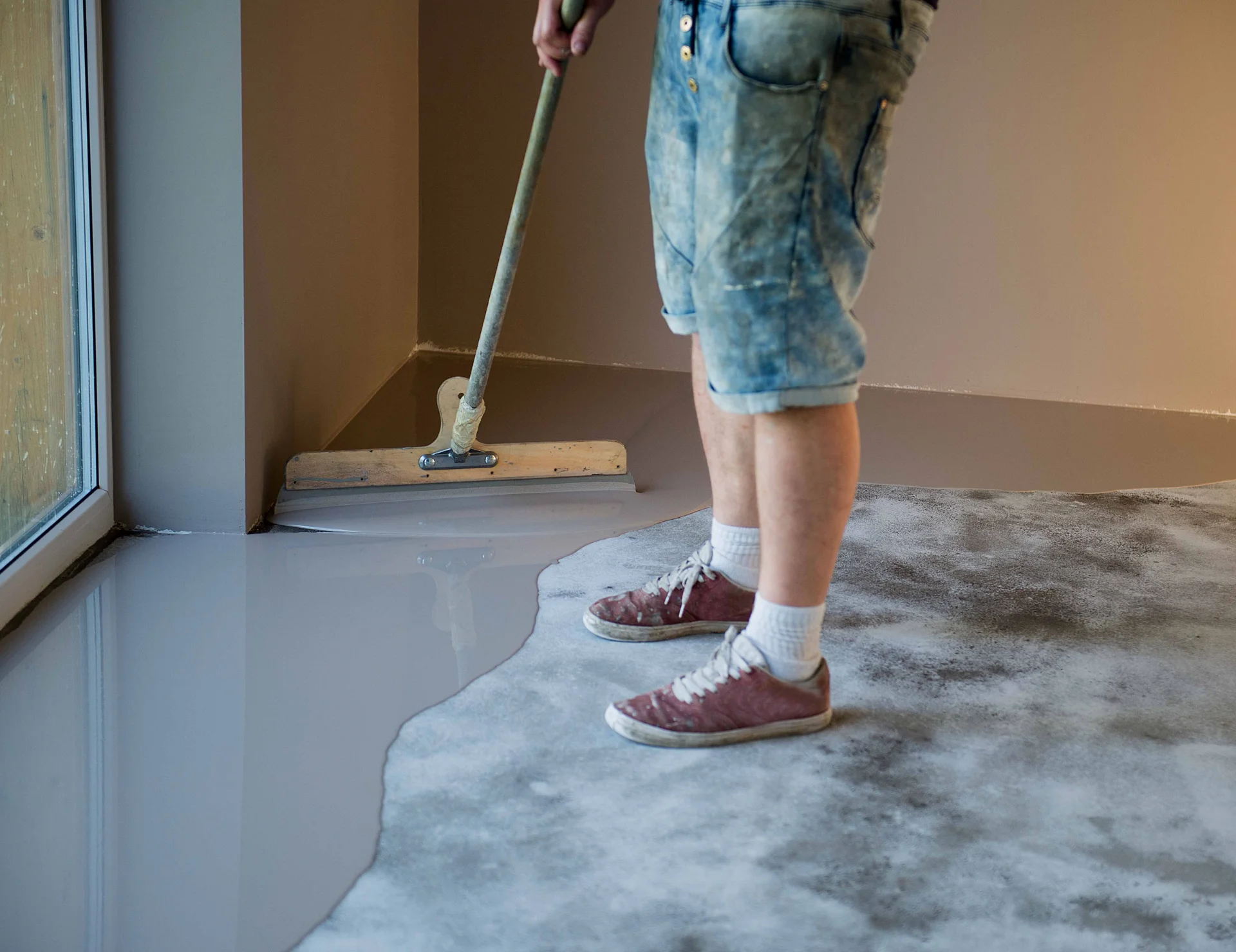 Epoxy coating being applied on interior concrete floor