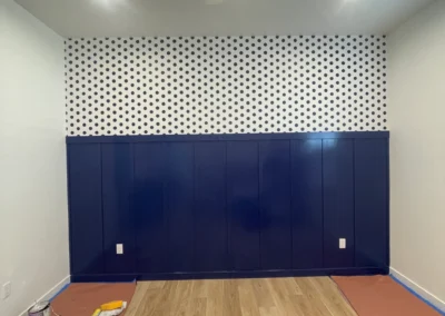 Accent wall with blue lower panel and wallpaper
