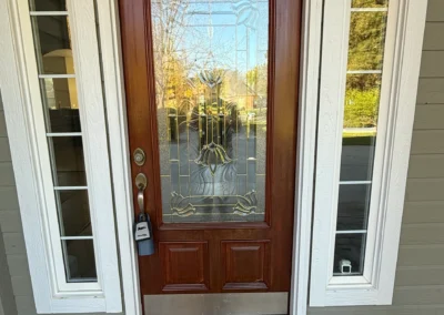 Front entry door with stained wood finish and glass panel design