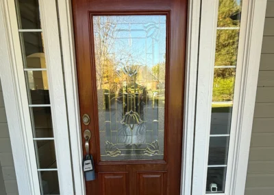 Wood front door with stained finish and glass panel